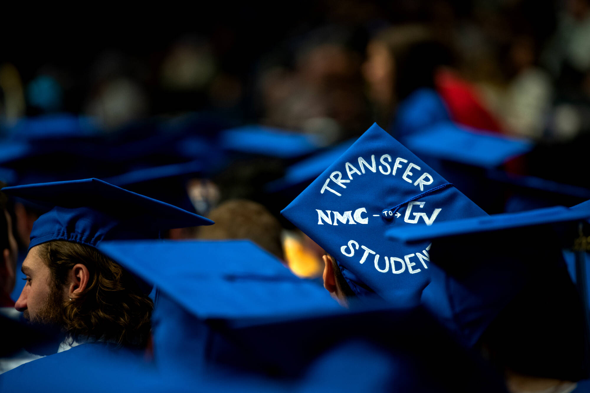 student wearing grad cap that says "Transfer NMC to GV student"